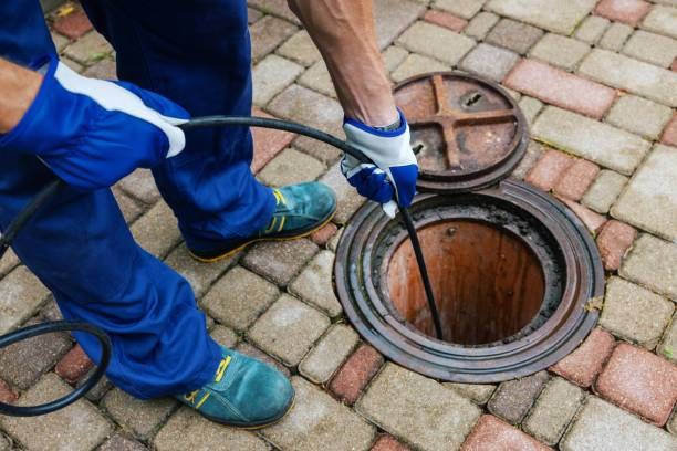Sewer and drain cleaning equipment clearing a line
