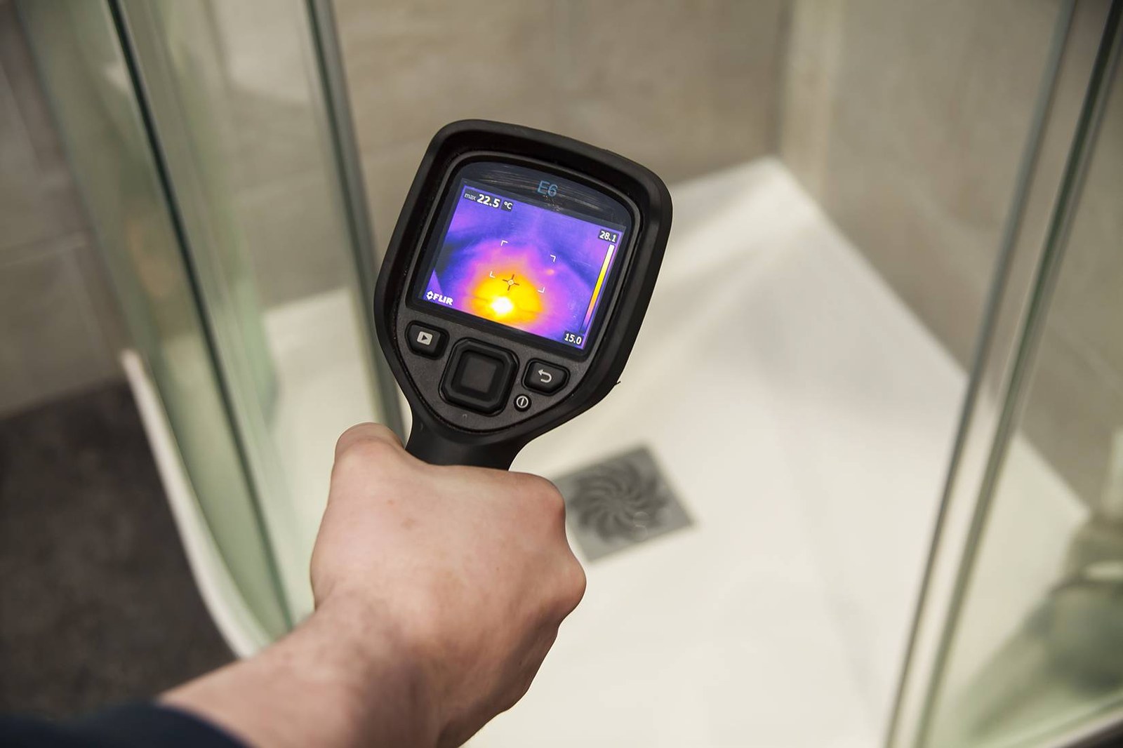 Plumber locating a hidden water leak in a home